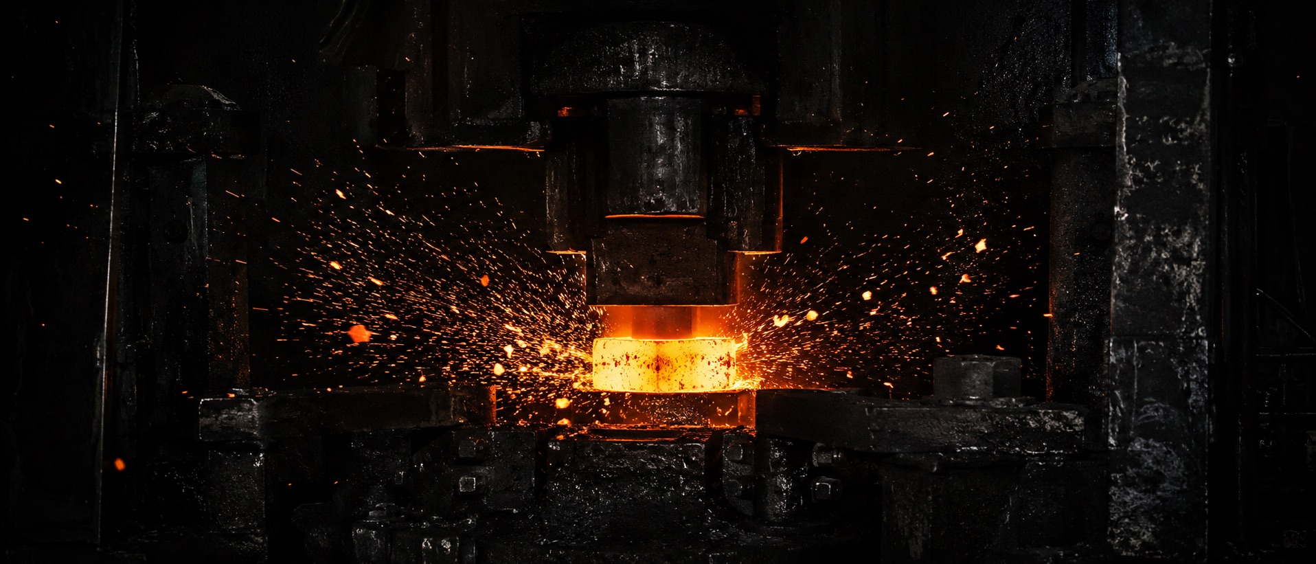 An industrial forging press striking glowing steel, sparks scattering into darkness